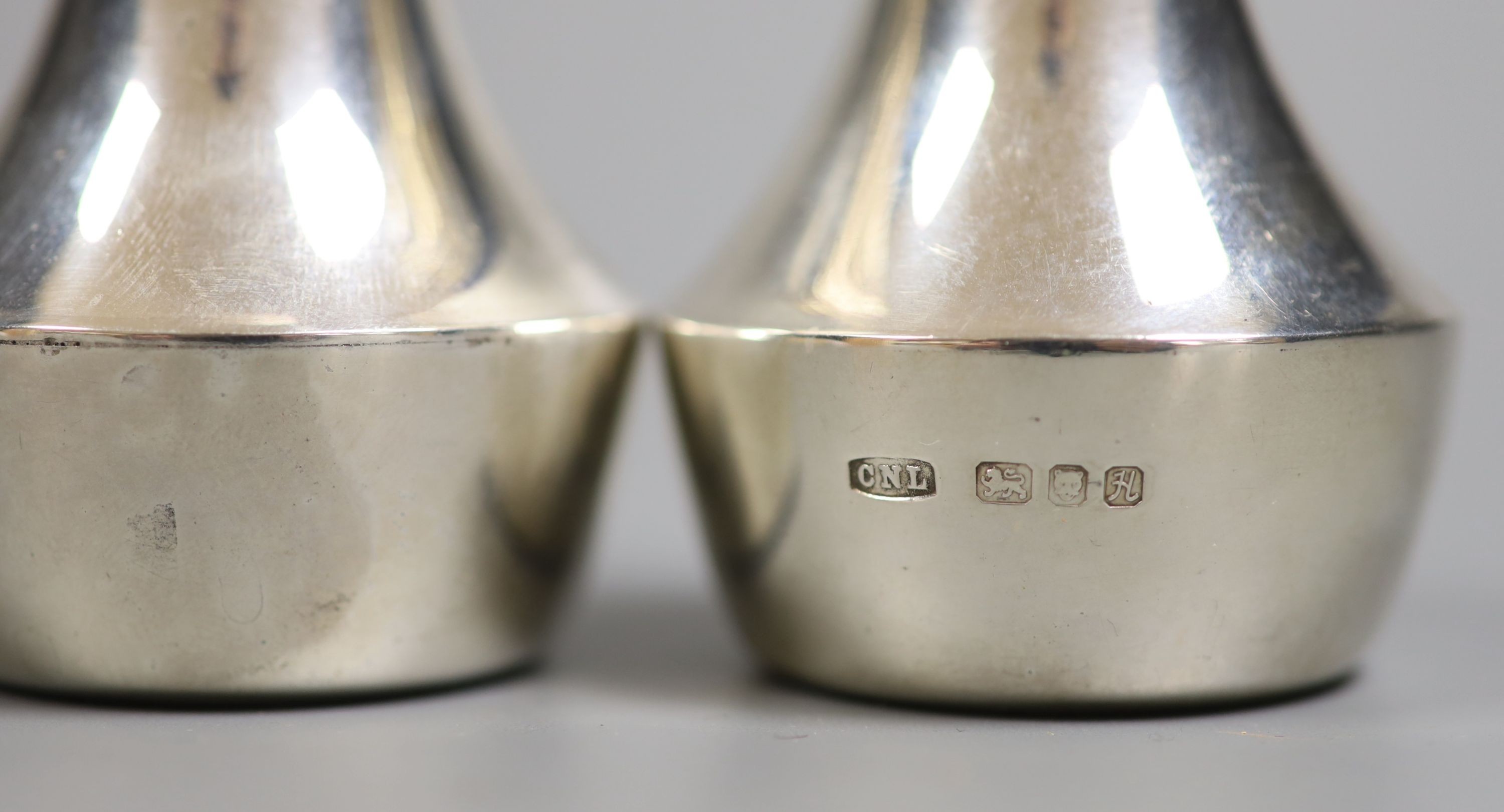 A modern pair of part textured silver condiments by Christopher Nigel Lawrence, London, 1982, 93mm, gross 141 grams.